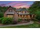 A charming two-story home with a brick facade, stone accents, and a welcoming front porch at 408 Covington Xing, Matthews, NC 28104