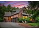 Elegant brick home features a three-car garage and inviting outdoor seating at 408 Covington Xing, Matthews, NC 28104