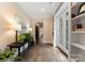 Inviting hallway with dark hardwood floors, elegant decor, and bright natural light from a door with glass panes at 408 Covington Xing, Matthews, NC 28104