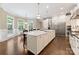 Open kitchen features a large island, stainless steel appliances, eat-in breakfast area and hardwood floors at 408 Covington Xing, Matthews, NC 28104