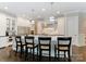 Bright kitchen with stainless steel appliances, white cabinets, island with seating, and pendant lighting at 408 Covington Xing, Matthews, NC 28104