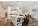 Bright kitchen features a large island with seating, stainless steel appliances, and white cabinetry at 408 Covington Xing, Matthews, NC 28104