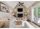 Bright living room features vaulted ceilings, a fireplace, and access to the deck at 408 Covington Xing, Matthews, NC 28104
