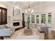 Bright living room featuring a stone fireplace, coffered ceilings, and a neutral color palette at 408 Covington Xing, Matthews, NC 28104