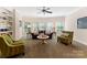 Open and inviting living room with large windows, comfortable seating, and a ceiling fan at 408 Covington Xing, Matthews, NC 28104