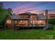 Expansive back exterior with large patio perfect for entertaining with a lawn and lots of space at 408 Covington Xing, Matthews, NC 28104