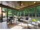 Inviting screened-in porch featuring comfortable seating and views of the backyard with a ceiling fan at 408 Covington Xing, Matthews, NC 28104