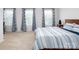 Spacious bedroom filled with natural light, featuring multiple windows and modern bedding at 4177 Steel Way, Sherrills Ford, NC 28673