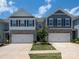 Charming townhome featuring stone accents, a two-car garage, and a well-manicured lawn with beautiful landscaping at 4177 Steel Way, Sherrills Ford, NC 28673