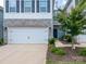 Charming townhome featuring stone accents, a two-car garage, and a small tree in the front yard at 4177 Steel Way, Sherrills Ford, NC 28673
