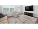 Bright living room features hardwood floors, natural light, and a modern entertainment center at 4177 Steel Way, Sherrills Ford, NC 28673