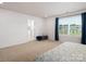 Bright main bedroom with a window, bench, and bathroom view at 4177 Steel Way, Sherrills Ford, NC 28673