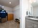 Spacious walk-in closet with shelving units, adjacent to a stylish vanity area at 4177 Steel Way, Sherrills Ford, NC 28673