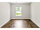 Bright, unfurnished bedroom with wood-look flooring and natural light from a large window at 429 Merry Go Dr, York, SC 29745