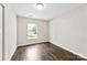 A clean and well-lit bedroom, features wood-look floors and large windows at 429 Merry Go Dr, York, SC 29745