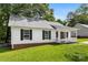 View of the side exterior of a quaint white home with black shutters at 429 Merry Go Dr, York, SC 29745