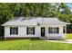 Charming single-story home with black shutters, a well-manicured lawn, and a quaint front porch at 429 Merry Go Dr, York, SC 29745