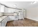 A bright kitchen with white cabinets, modern appliances, and wood-look flooring at 429 Merry Go Dr, York, SC 29745