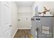Functional laundry room with modern water heater and shelving for storage at 429 Merry Go Dr, York, SC 29745