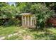 Backyard shed with a wooden base surrounded by greenery at 4312 Mary Point Rd, Monroe, NC 28110