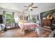 Bright bedroom with a four-poster bed, wood floors, and plenty of natural light from the window at 4312 Mary Point Rd, Monroe, NC 28110