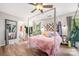 Bedroom featuring wood flooring, a canopy bed, and a view through a window to the outdoors at 4312 Mary Point Rd, Monroe, NC 28110
