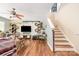 Inviting living room with modern decor, ceiling fan, hardwood floors, and a staircase at 4312 Mary Point Rd, Monroe, NC 28110