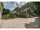 Exterior view of a home featuring a spacious backyard with a deck, garage and mature trees, enhancing privacy at 5014 Quail Canyon Dr, Charlotte, NC 28226