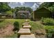 View of the backyard featuring a deck, expansive lawn, and mature trees, perfect for outdoor activities at 5014 Quail Canyon Dr, Charlotte, NC 28226