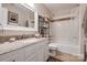 Bright bathroom featuring white vanity, granite countertop, and a bathtub with decorative tile surround at 5014 Quail Canyon Dr, Charlotte, NC 28226