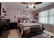 Stylishly decorated bedroom featuring a large bed, dark wood furniture, and unique wall decor at 5014 Quail Canyon Dr, Charlotte, NC 28226