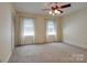 Spacious bedroom with neutral carpet, large windows, and ceiling fan offers a comfortable retreat at 5014 Quail Canyon Dr, Charlotte, NC 28226