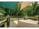 Large, partially shaded deck with metal railing overlooking the manicured yard and lush greenery at 5014 Quail Canyon Dr, Charlotte, NC 28226