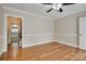 Empty dining room featuring hardwood floors, neutral walls, and crown molding with a view to the kitchen at 5014 Quail Canyon Dr, Charlotte, NC 28226