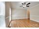Empty dining room featuring hardwood floors, neutral walls, crown molding, and natural light at 5014 Quail Canyon Dr, Charlotte, NC 28226