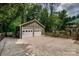 Exterior shot of a detached two-car garage with a spacious driveway and surrounding greenery, ideal for car enthusiasts at 5014 Quail Canyon Dr, Charlotte, NC 28226