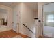 Well-lit hallway with hardwood floors, white wainscoting, and views into adjacent rooms at 5014 Quail Canyon Dr, Charlotte, NC 28226