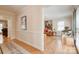 Hallway with hardwood floors leading to a living room with neutral walls and classic decor at 5014 Quail Canyon Dr, Charlotte, NC 28226