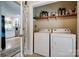 Cozy laundry area features washer, dryer, and overhead storage, conveniently located near the kitchen at 5014 Quail Canyon Dr, Charlotte, NC 28226