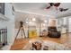 Living room featuring a fireplace, built-in shelving, hardwood floors and unique decor at 5014 Quail Canyon Dr, Charlotte, NC 28226