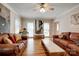 Spacious living room featuring hardwood floors, leather sofas, and large windows with natural light at 5014 Quail Canyon Dr, Charlotte, NC 28226