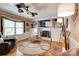 Cozy living room featuring a fireplace, built-in shelving, and hardwood floors at 5014 Quail Canyon Dr, Charlotte, NC 28226