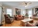 Inviting living room with hardwood floors, ceiling fan, leather sofa and arm chair at 5014 Quail Canyon Dr, Charlotte, NC 28226