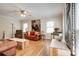 Bright living room featuring hardwood floors, large windows, and leather sofas at 5014 Quail Canyon Dr, Charlotte, NC 28226