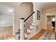 Staircase with hardwood steps and patterned carpet runner, connecting to a hallway with hardwood floors at 5014 Quail Canyon Dr, Charlotte, NC 28226