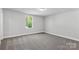 Carpeted bedroom with natural light from a window overlooking a lush, green landscape at 5208 Admirals Lndg, Lancaster, SC 29720