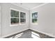 Sunlit bedroom with hardwood floors and large windows showcasing the private backyard at 5208 Admirals Lndg, Lancaster, SC 29720