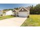 A single Gathering home with neutral siding, well-manicured lawn, and a two-car garage at 5208 Admirals Lndg, Lancaster, SC 29720