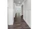 Bright hallway featuring dark wood-look floors, wainscoting, and contemporary lighting at 5208 Admirals Lndg, Lancaster, SC 29720