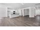 Spacious living room with hardwood floors adjacent to the open-concept kitchen and stairs at 5208 Admirals Lndg, Lancaster, SC 29720